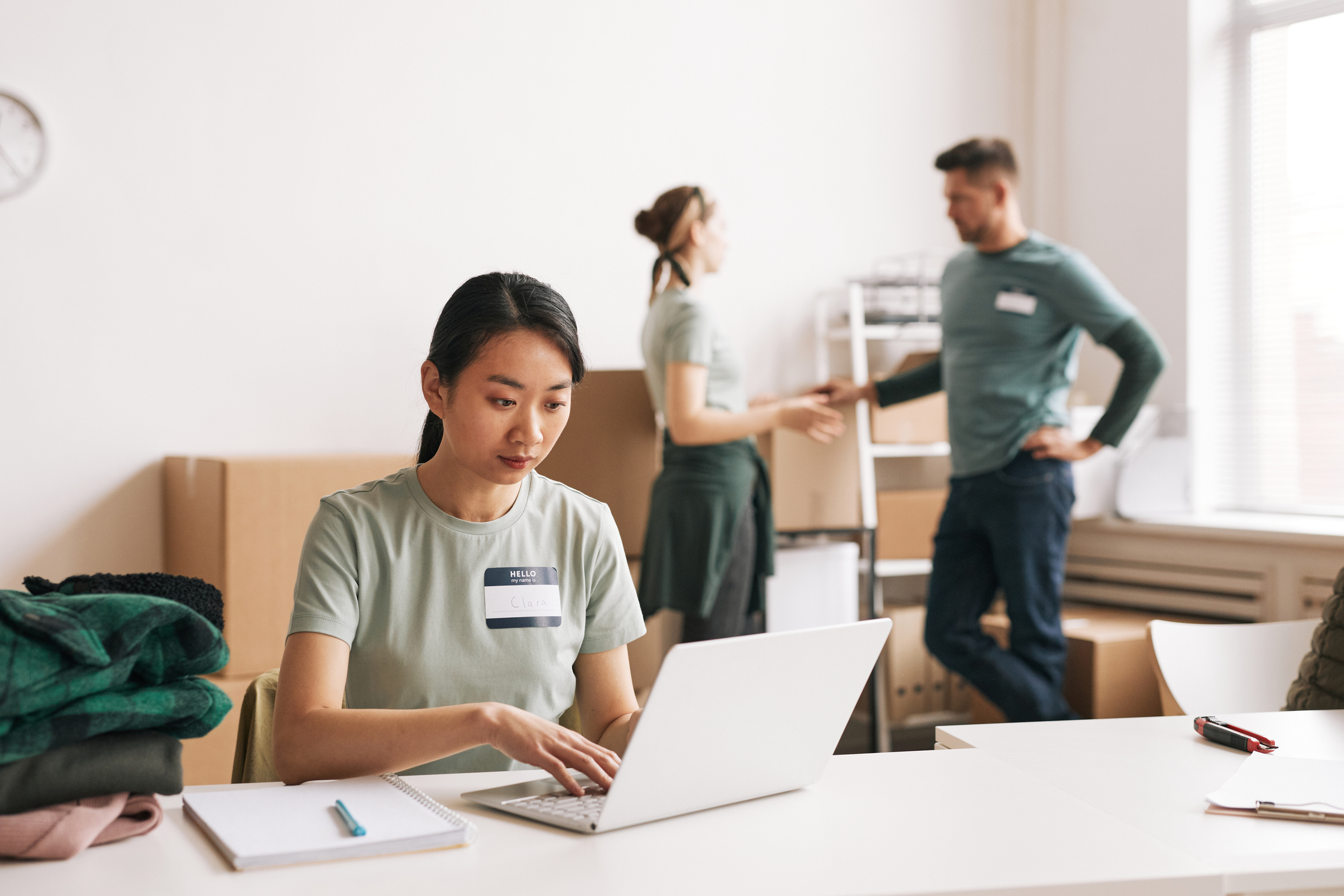 Diverse group of volunteers organizing boxes during help and donations event