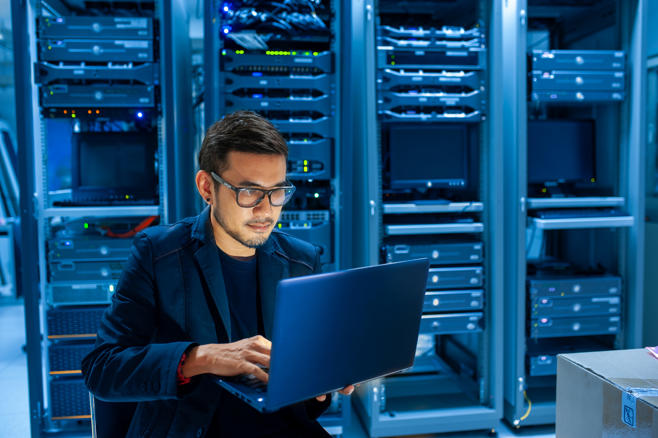 Man fixing server in data center room .