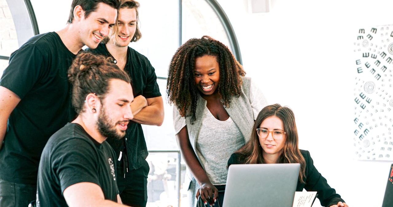 team checking their systems on a laptop
