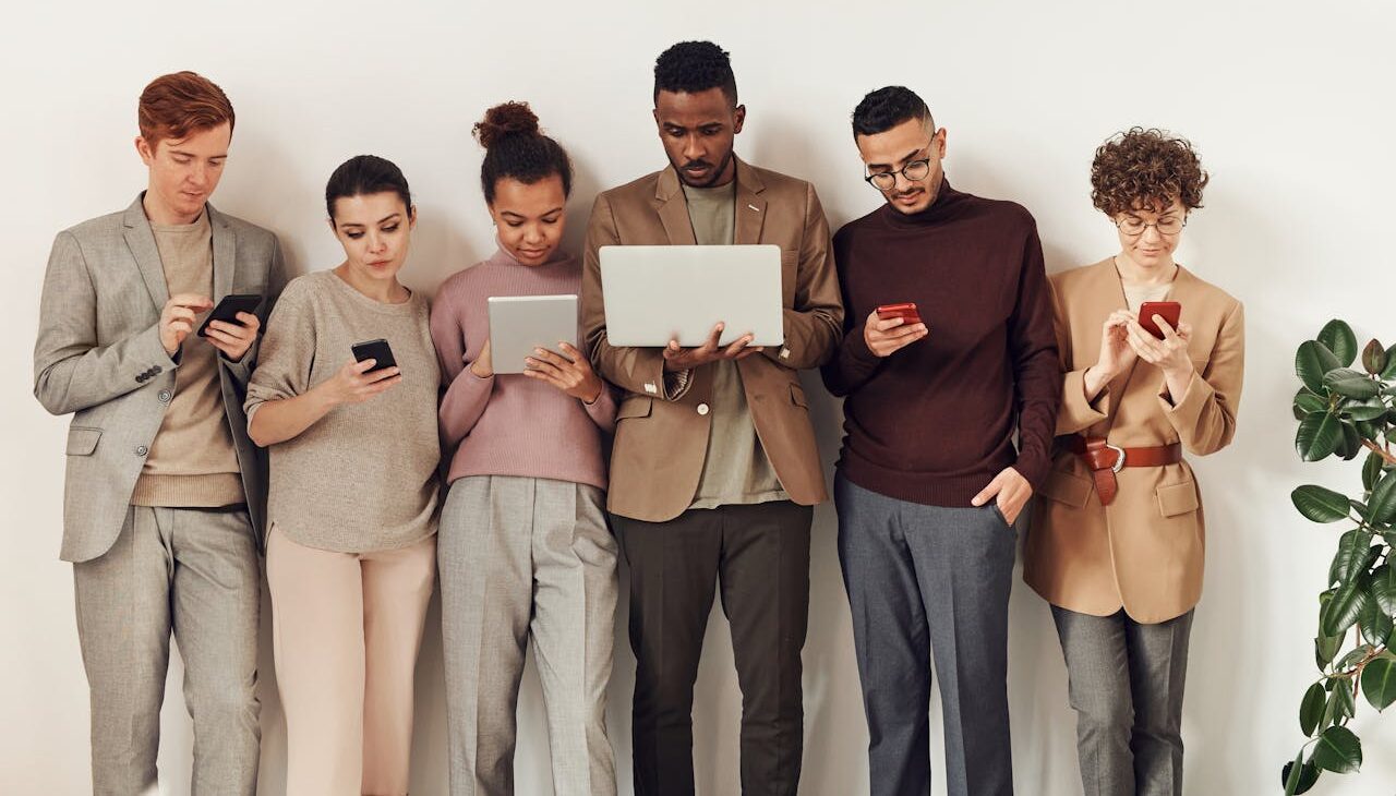 people in the office using different gadgets