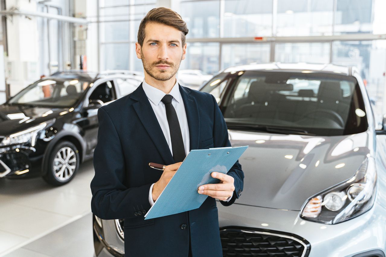 salesperson in a car showroom at a car dealer